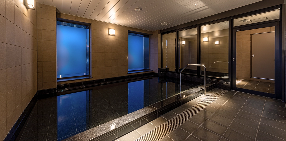 Relax and unwind from your travels in the large public bath on the 19th floor.